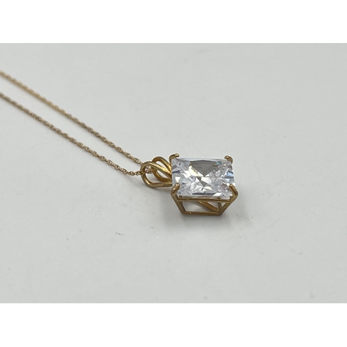 2357 - A 9ct gold cubic zirconia star burst pendant necklace with certificate of authenticity - approx. gro... 