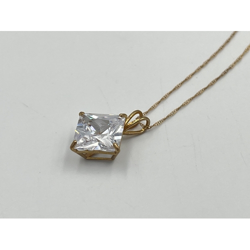 2357 - A 9ct gold cubic zirconia star burst pendant necklace with certificate of authenticity - approx. gro... 