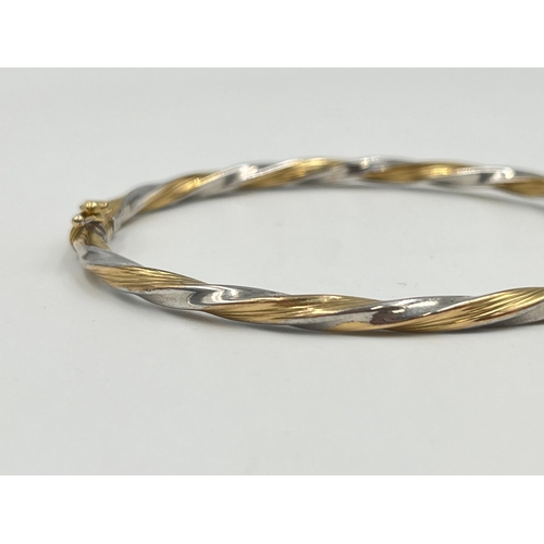 2364 - A 9ct yellow and white gold twisted bangle - approx. gross weight 3.85g