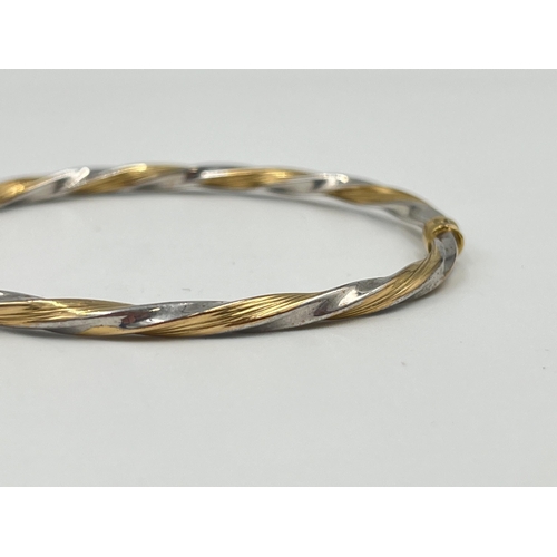 2364 - A 9ct yellow and white gold twisted bangle - approx. gross weight 3.85g