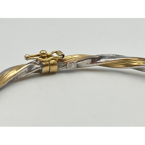 2364 - A 9ct yellow and white gold twisted bangle - approx. gross weight 3.85g