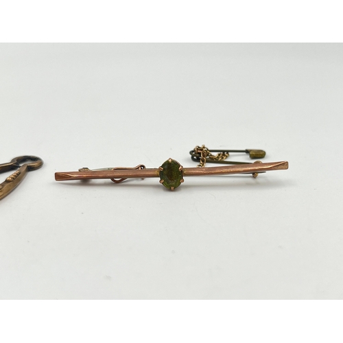 2373 - Two pieces of jewellery, one 9ct gold peridot set brooch with base metal pin and one yellow metal ea... 