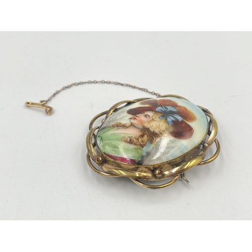 2379 - A yellow metal framed porcelain portrait brooch with base metal pin - approx. gross weight 21g and 7... 