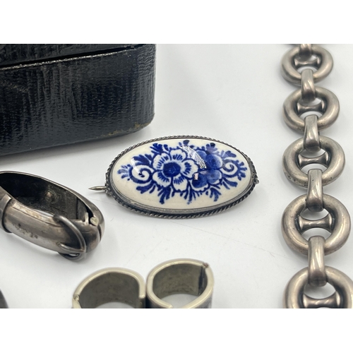 2384 - An early 20th century black leather jewellery box containing silver and white metal jewellery to inc... 