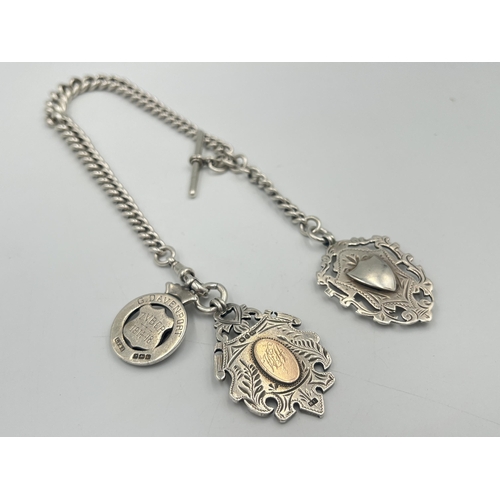 2550 - An Edwardian Herbert Bushell hallmarked Birmingham silver albert chain with T bar and three fobs, da... 