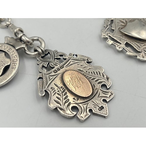 2550 - An Edwardian Herbert Bushell hallmarked Birmingham silver albert chain with T bar and three fobs, da... 