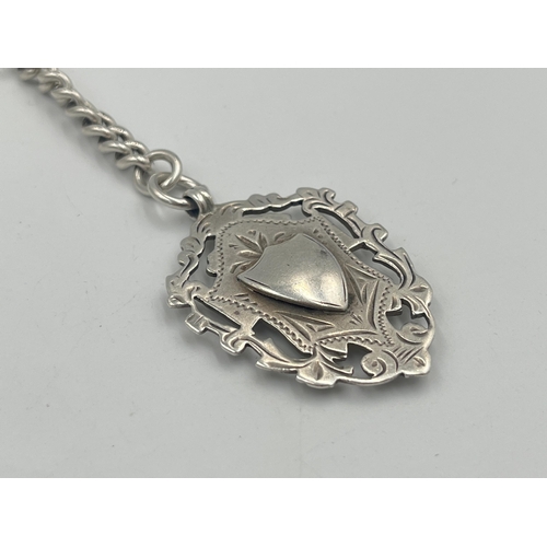 2550 - An Edwardian Herbert Bushell hallmarked Birmingham silver albert chain with T bar and three fobs, da... 