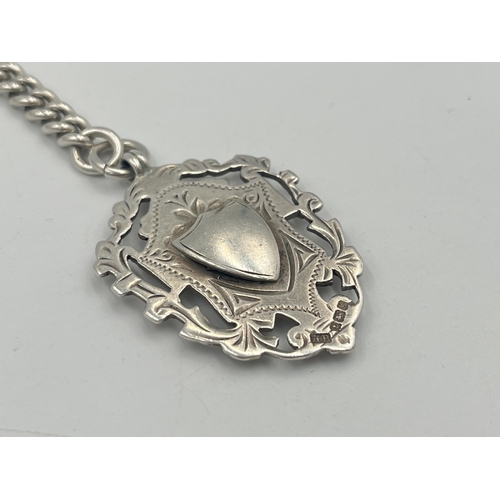 2550 - An Edwardian Herbert Bushell hallmarked Birmingham silver albert chain with T bar and three fobs, da... 