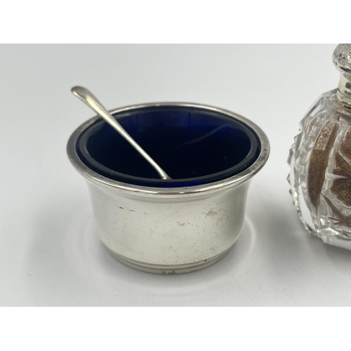 2553 - Three items, one hallmarked Birmingham silver condiment pot with spoon and two cut glass pepper shak... 