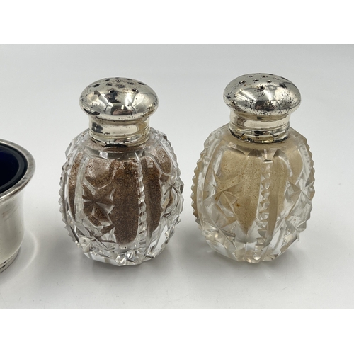 2553 - Three items, one hallmarked Birmingham silver condiment pot with spoon and two cut glass pepper shak... 