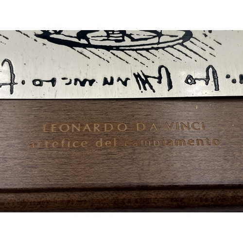 2554 - A hallmarked .800 silver Leonardo Da Vinci of 'Artefice Del Cambiamento' on mahogany plaque