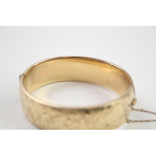 2018 - A rolled gold bangle with etched foliate design - approx. gross weight 41g