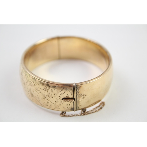 2018 - A rolled gold bangle with etched foliate design - approx. gross weight 41g