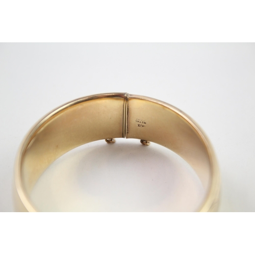 2018 - A rolled gold bangle with etched foliate design - approx. gross weight 41g