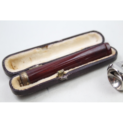 2158 - Four sterling silver tobacciana items, two vesta cases, cigar cutter etc. - approx. gross weight 72g