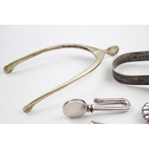 2176 - Five .925 sterling silver items, three napkin clips, one toothpick and one pair of sugar tongs - app... 