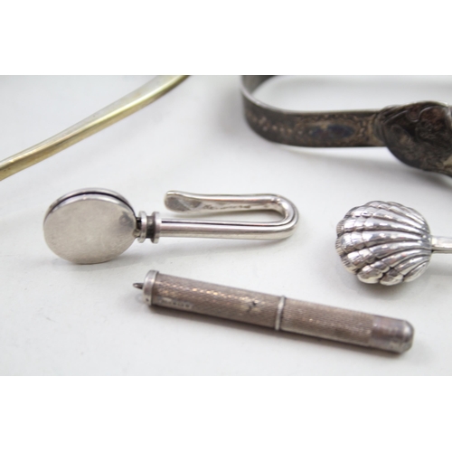 2176 - Five .925 sterling silver items, three napkin clips, one toothpick and one pair of sugar tongs - app... 