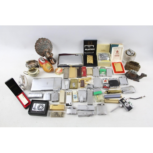 500 - A large collection of cigarette lighters to include table lighters, novelty lighters etc.