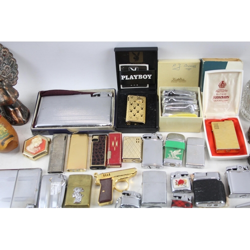 500 - A large collection of cigarette lighters to include table lighters, novelty lighters etc.