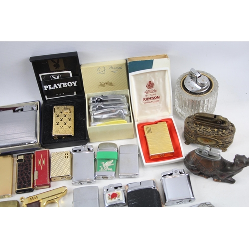 500 - A large collection of cigarette lighters to include table lighters, novelty lighters etc.