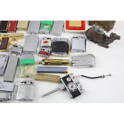 500 - A large collection of cigarette lighters to include table lighters, novelty lighters etc.