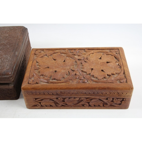 505 - Three Indian carved teak jewellery boxes - largest approx. 8cm high x 29cm wide x 19cm deep