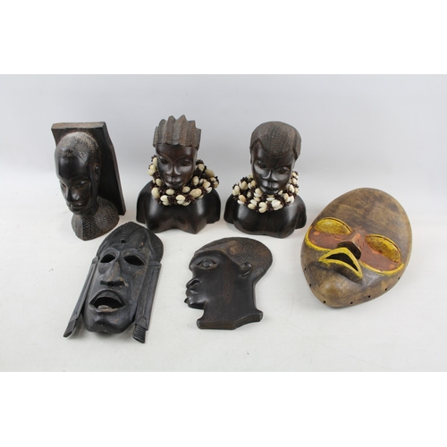 518 - A collection of African ornaments to include tribal masks, ebony busts, hand carved sculptures etc.