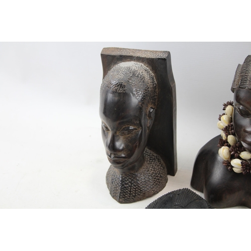 518 - A collection of African ornaments to include tribal masks, ebony busts, hand carved sculptures etc.