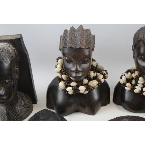 518 - A collection of African ornaments to include tribal masks, ebony busts, hand carved sculptures etc.