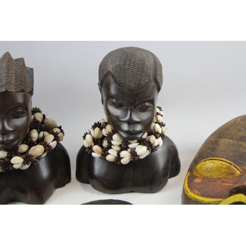 518 - A collection of African ornaments to include tribal masks, ebony busts, hand carved sculptures etc.