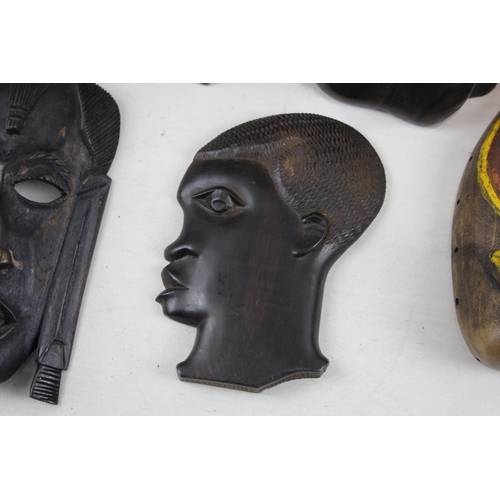 518 - A collection of African ornaments to include tribal masks, ebony busts, hand carved sculptures etc.