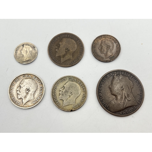 2185 - Six British coins to include two George V silver shillings, Victorian silver threepence etc.