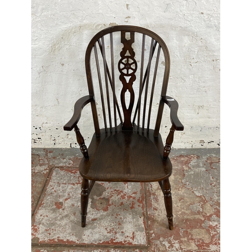 251 - A 19th century style elm and beech wheelback armchair