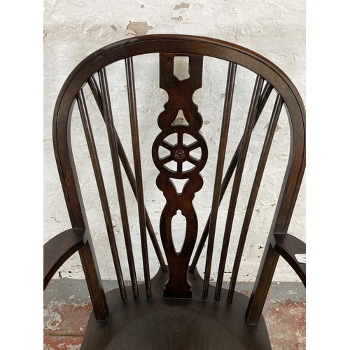 251 - A 19th century style elm and beech wheelback armchair