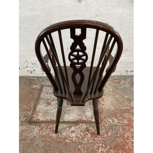 251 - A 19th century style elm and beech wheelback armchair