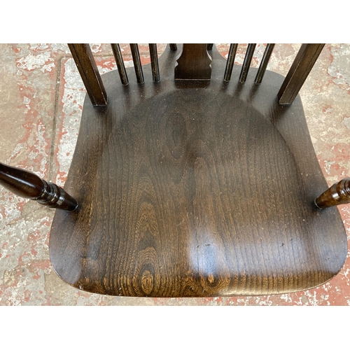 251 - A 19th century style elm and beech wheelback armchair