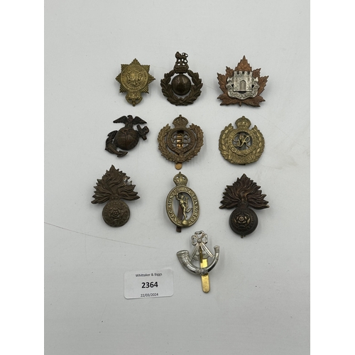 2364 - A collection of military cap badges