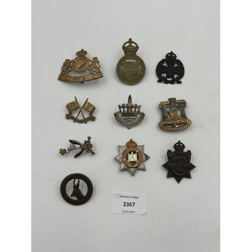 2367 - A collection of military cap badges