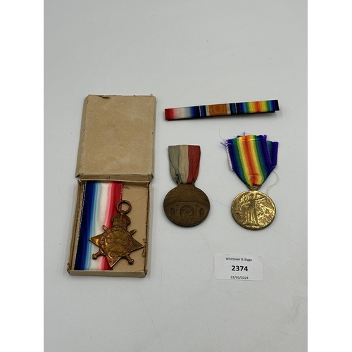 2374 - Three medals, one WWI medal pair comprising unnamed 1914-15 star and Victory presented to 30957 Pte.... 