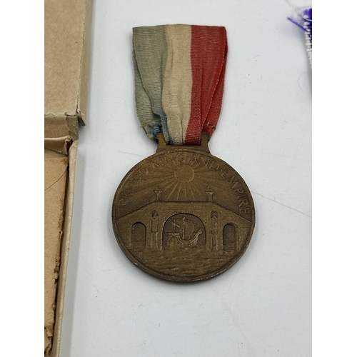 2374 - Three medals, one WWI medal pair comprising unnamed 1914-15 star and Victory presented to 30957 Pte.... 