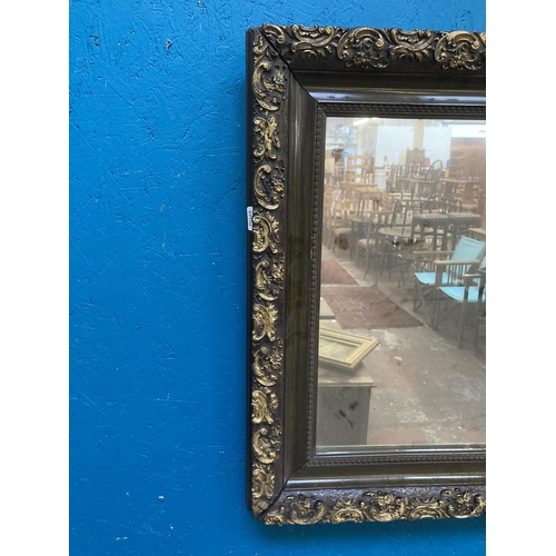 273 - A late 19th/early 20th century ebonised and gilt framed wall mirror - approx. 55cm high x 65cm wide