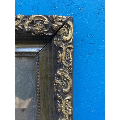 273 - A late 19th/early 20th century ebonised and gilt framed wall mirror - approx. 55cm high x 65cm wide