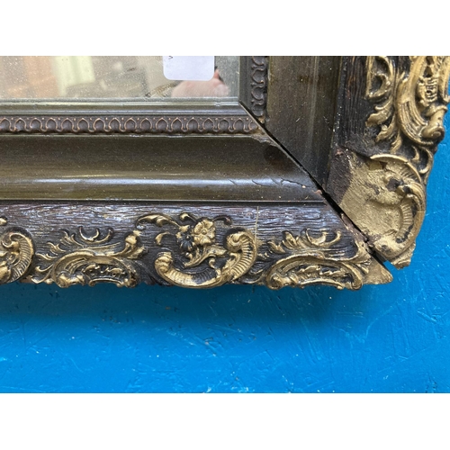 273 - A late 19th/early 20th century ebonised and gilt framed wall mirror - approx. 55cm high x 65cm wide