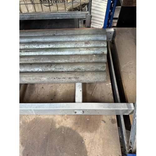 898 - A quantity of scaffolding accessories to include aluminium ladder, seven steel poles and a box of sc... 