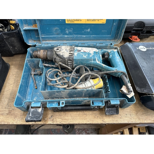 912 - Two cased Makita drills, one 8280D cordless combi drill and one 8406 corded masonry drill