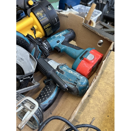 920 - Two boxes of power tools to include Makita 8391D cordless drill, Makita BSS610 cordless circular saw... 