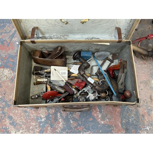 944 - A suitcase containing vintage hand tools