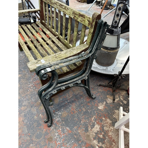 946 - Two green painted cast iron bench ends