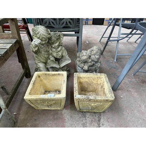 967 - Four cast stone garden items , two ornaments and two planters