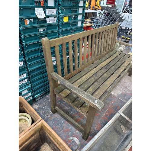 969 - A teak garden bench - approx. 90cm high x 158cm x 57cm deep